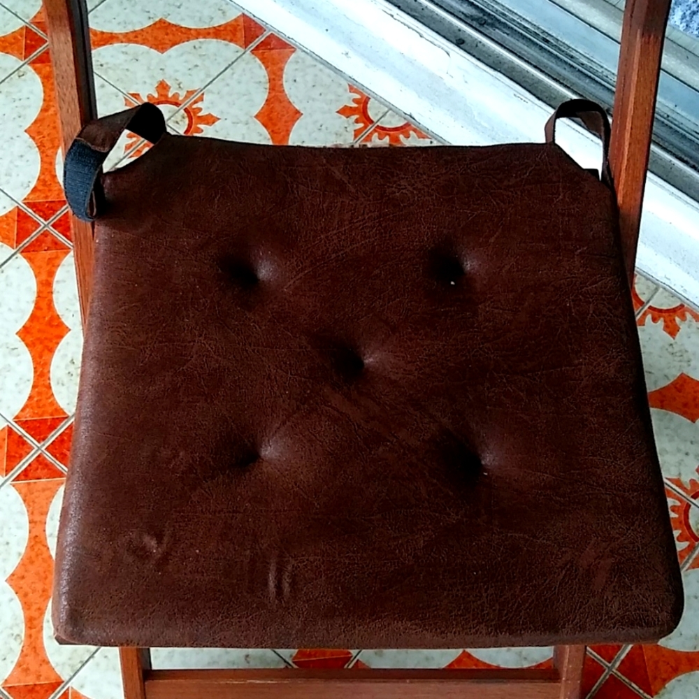 4 Brown leather looking seat cushions